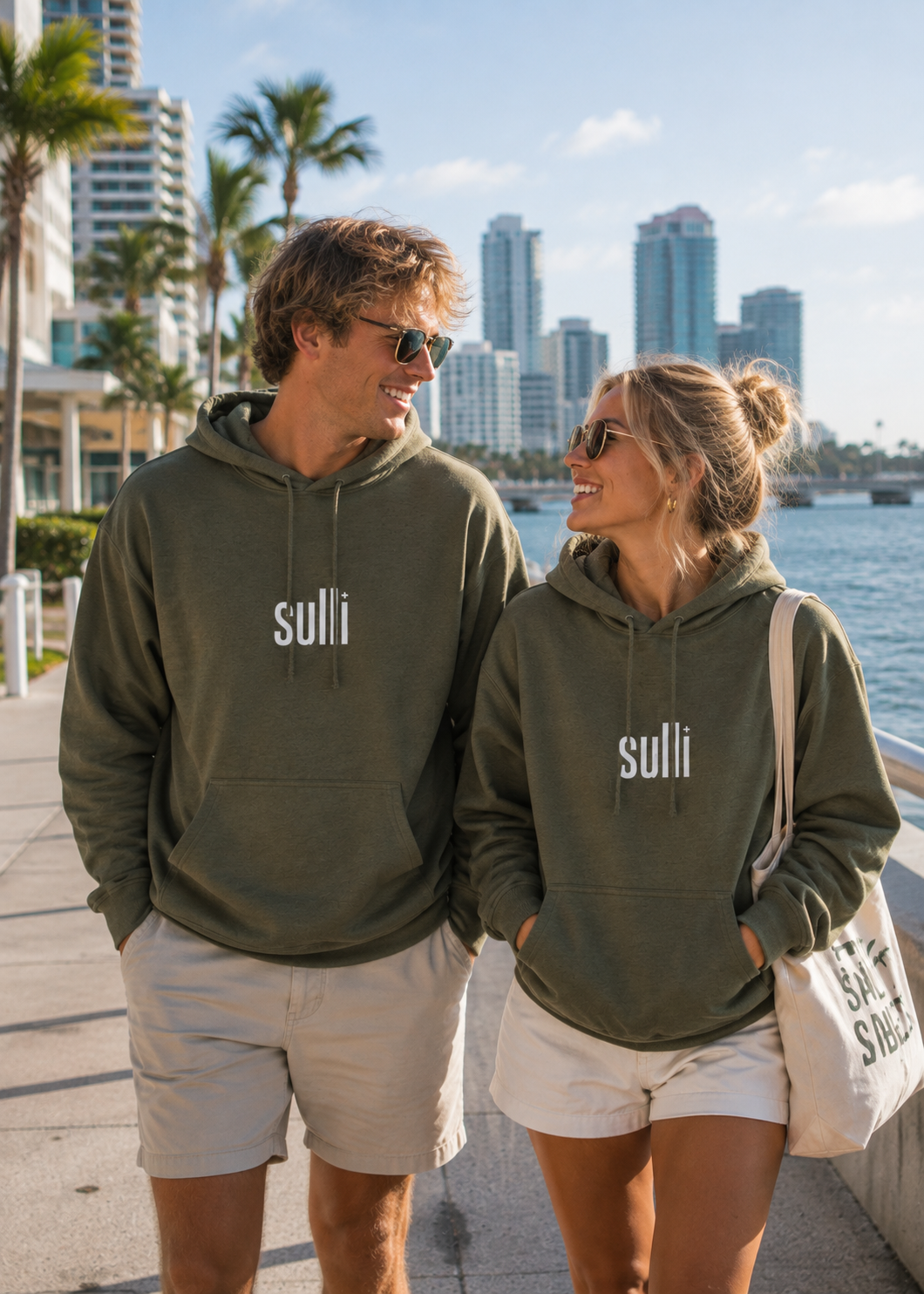 Couple walking with Green Unstoppable Hoodie with "Sulli" logo with hood and drawstring